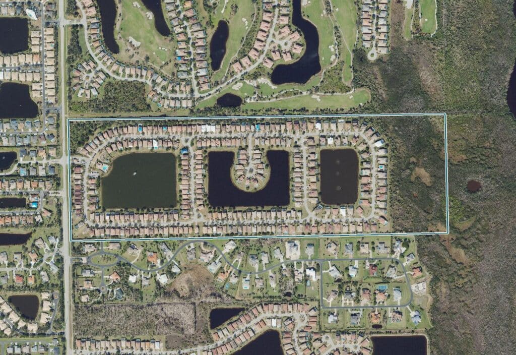 Aerial view of Catalina at Winkler, a gated single-family community in south Fort Myers, Florida, centered on three lakes, with the community boundary outlined